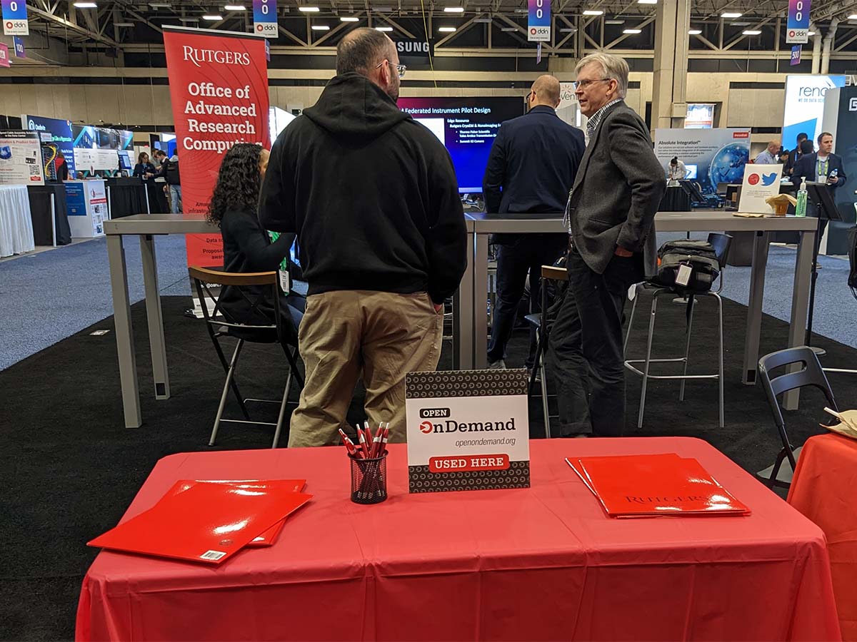 Rutgers University booth at SC22 with Open OnDemand placard