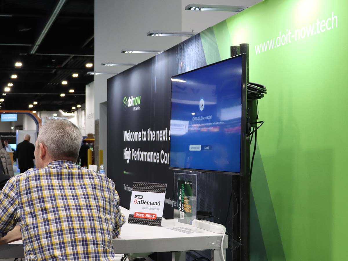 Do It Now booth at SC23 with Open OnDemand placard