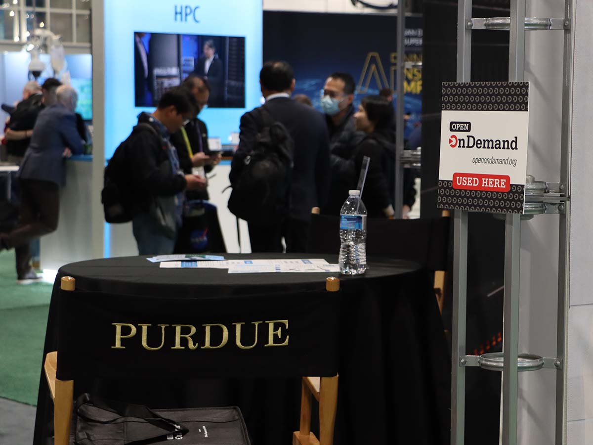 Purdue University booth at SC23 with Open OnDemand placard