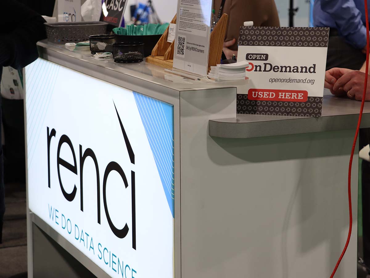 Rencì booth at SC23 with Open OnDemand placard